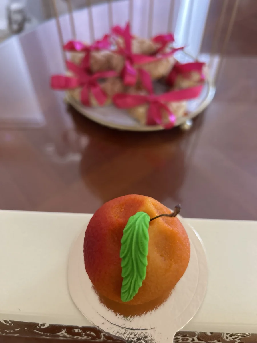 Pâtisserie fruitée orange et rouge avec une feuille verte
